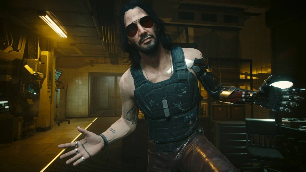 Johnny Silverhand, personagem de Cyberpunk 2077 interpretado por Keanu Reeves, usando óculos escuros e exibindo seu braço cibernético.